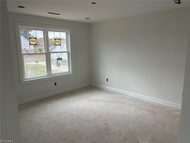 empty room featuring visible vents and baseboards