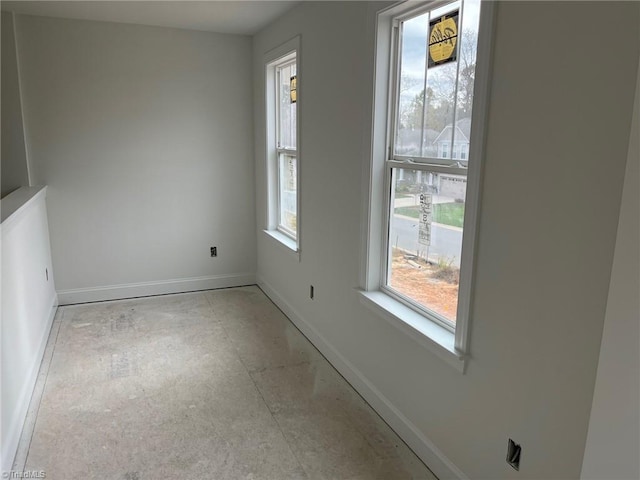 spare room featuring baseboards