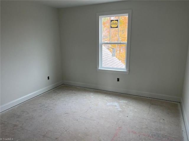 spare room featuring plenty of natural light and baseboards