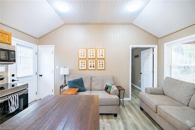 living area featuring light wood finished floors and vaulted ceiling