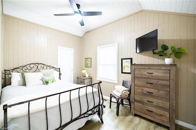 bedroom with light wood-type flooring, lofted ceiling, and a ceiling fan