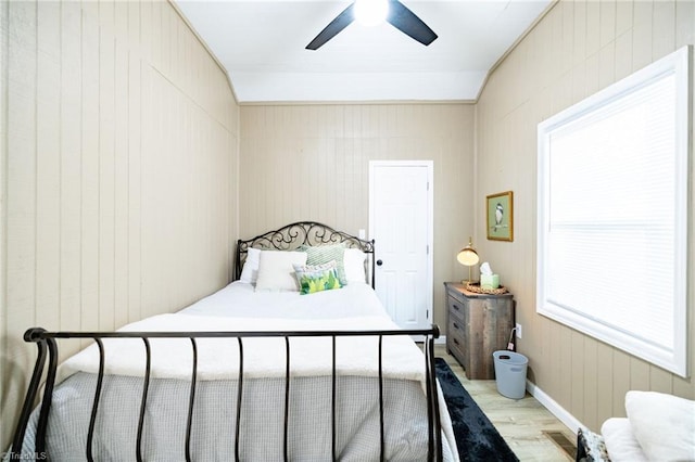 bedroom with wood finished floors, visible vents, and ceiling fan