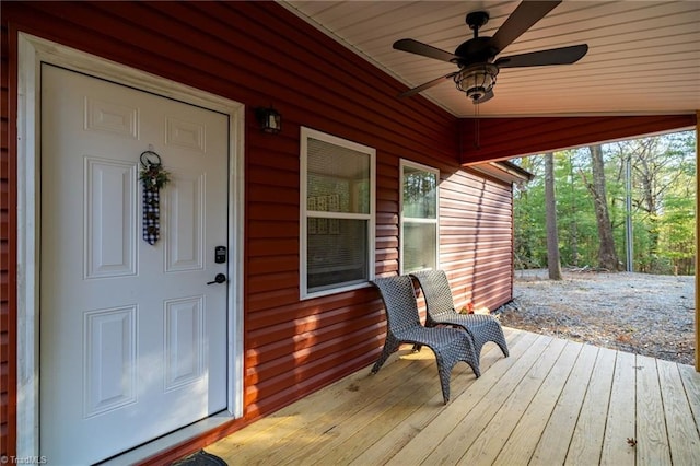 wooden terrace with a porch and a ceiling fan