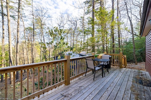 wooden terrace with outdoor dining area