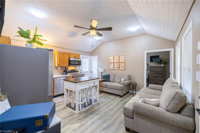 living area featuring ceiling fan, wooden ceiling, light wood-style floors, and vaulted ceiling