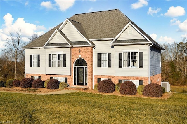 view of front of property with cooling unit and a front yard