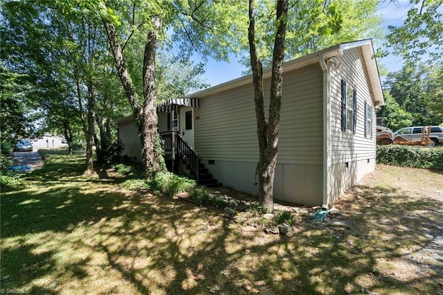 view of side of property with a lawn