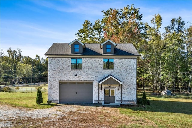 view of front of house with a front yard and a garage