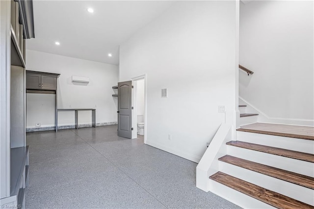 stairs featuring a wall unit AC