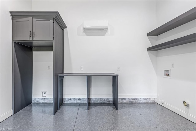 washroom with hookup for a washing machine, cabinets, and a wall mounted air conditioner