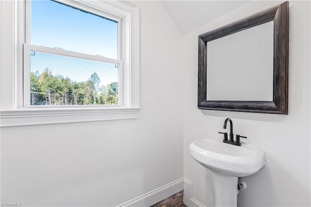 bathroom featuring sink and lofted ceiling