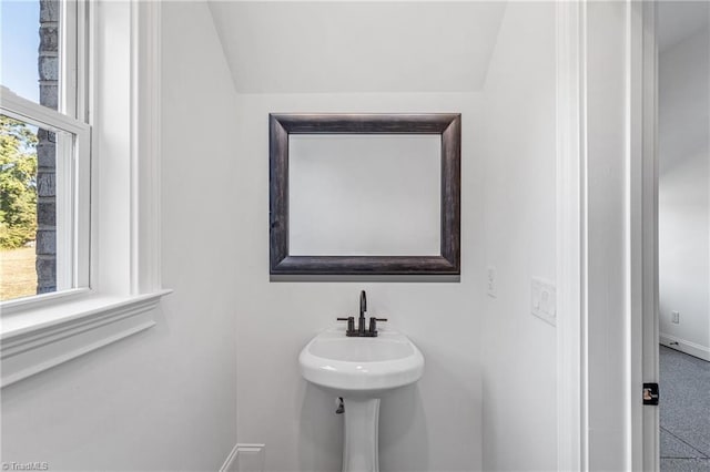 bathroom with lofted ceiling and a wealth of natural light