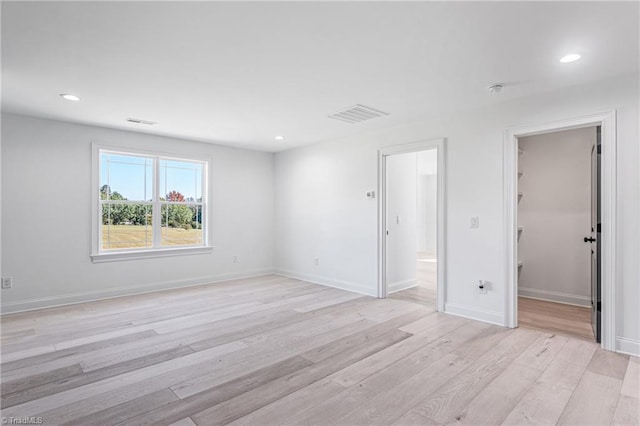 spare room featuring light hardwood / wood-style flooring