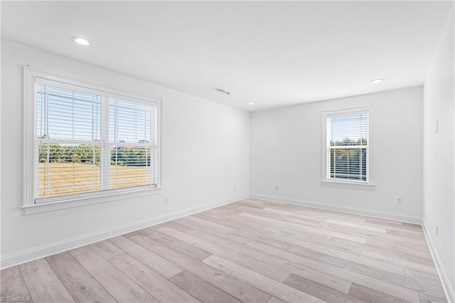 spare room with light hardwood / wood-style flooring