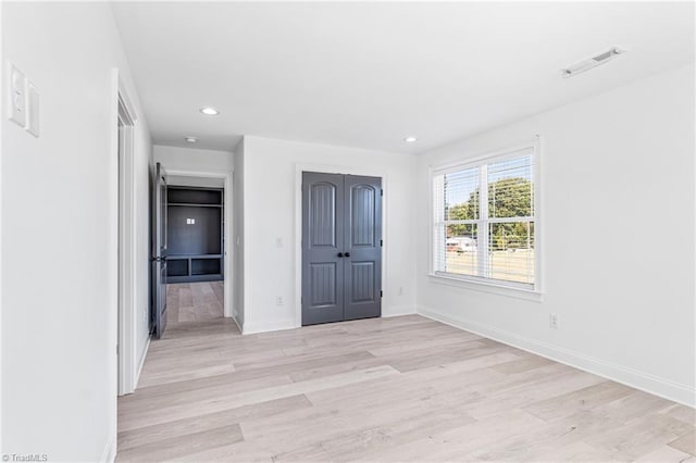 unfurnished bedroom with light hardwood / wood-style floors