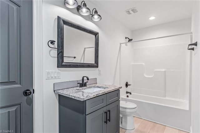 full bathroom featuring toilet, vanity, and shower / bathing tub combination