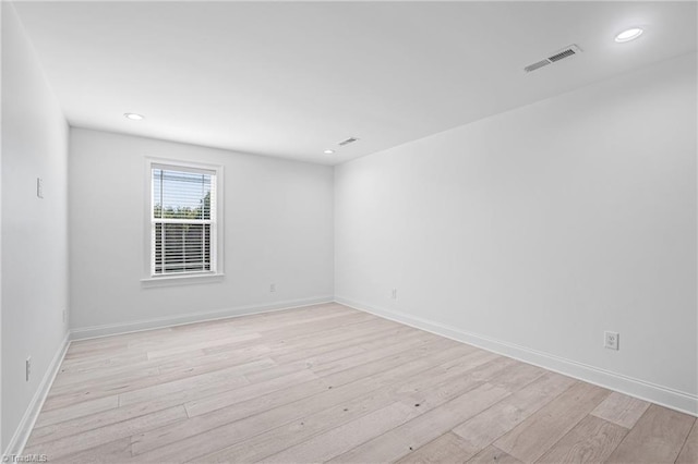 spare room with light hardwood / wood-style floors