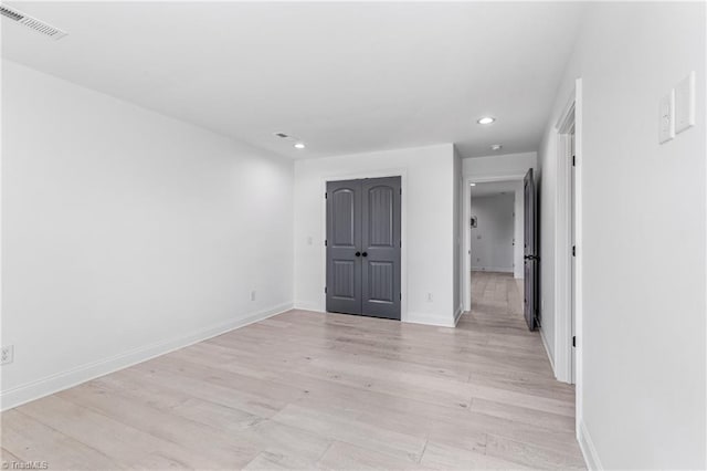 spare room featuring light hardwood / wood-style flooring