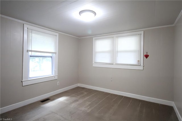 spare room with baseboards, carpet floors, and visible vents