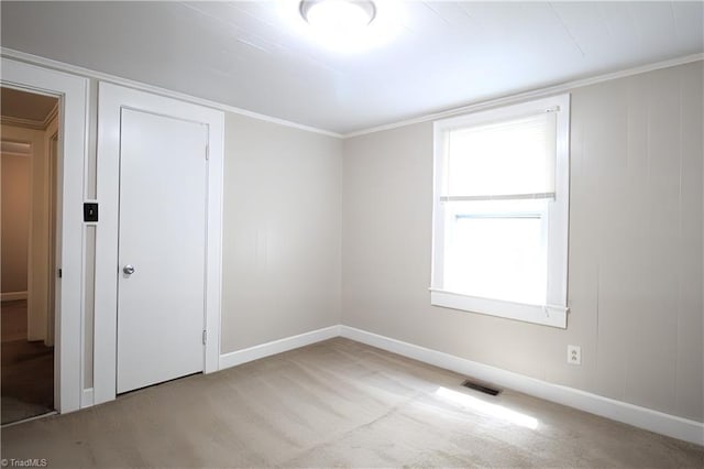 unfurnished room with baseboards, carpet flooring, and visible vents