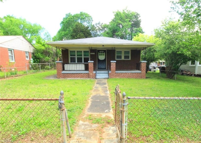 bungalow-style home with fence private yard, a porch, brick siding, and a front yard