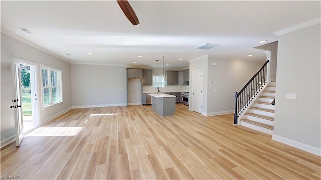 3043 Loch Dr, Winston-Salem, NC 27106 - unfurnished living room with ornamental molding, baseboards, stairway, recessed lighting, and light wood-type flooring