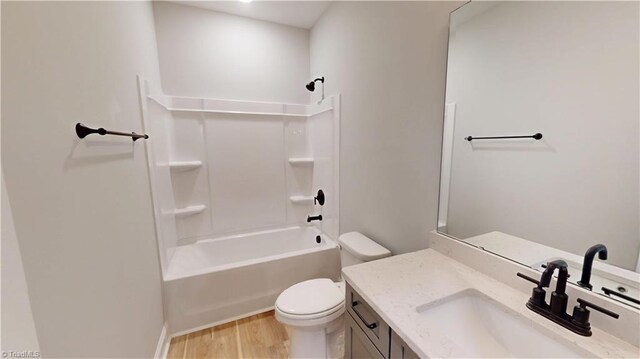 3043 Loch Dr, Winston-Salem, NC 27106 - full bath with toilet, vanity, wood finished floors, and shower / washtub combination