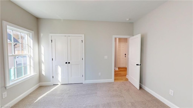 3043 Loch Dr, Winston-Salem, NC 27106 - unfurnished bedroom featuring carpet, baseboards, and a closet