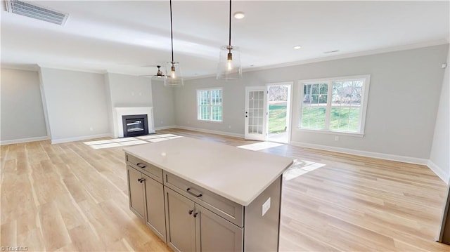3043 Loch Dr, Winston-Salem, NC 27106 - kitchen with ornamental molding, a ceiling fan, baseboards, pendant lighting, and light wood-type flooring