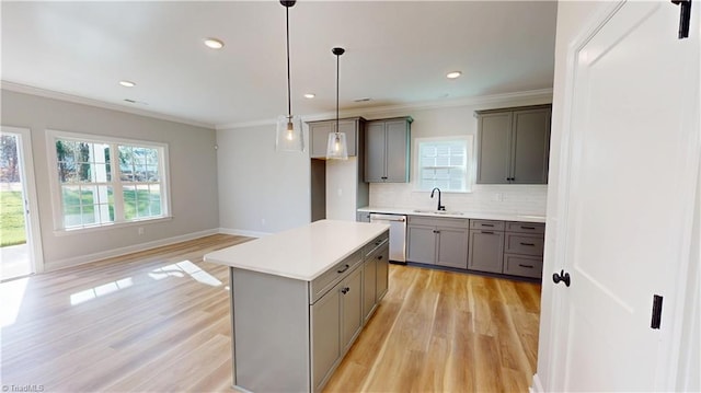 3043 Loch Dr, Winston-Salem, NC 27106 - kitchen featuring gray cabinetry, a sink, light wood-type flooring, healthy amount of natural light, and crown molding