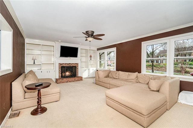 living room with carpet floors, a ceiling fan, and crown molding