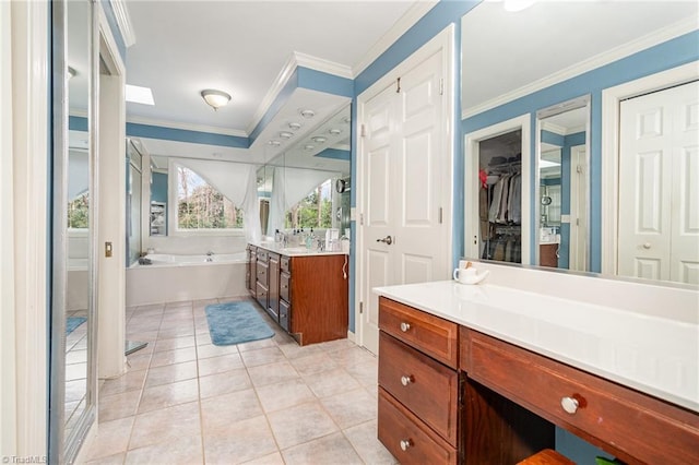 full bath featuring vanity, a spacious closet, crown molding, a bath, and tile patterned floors