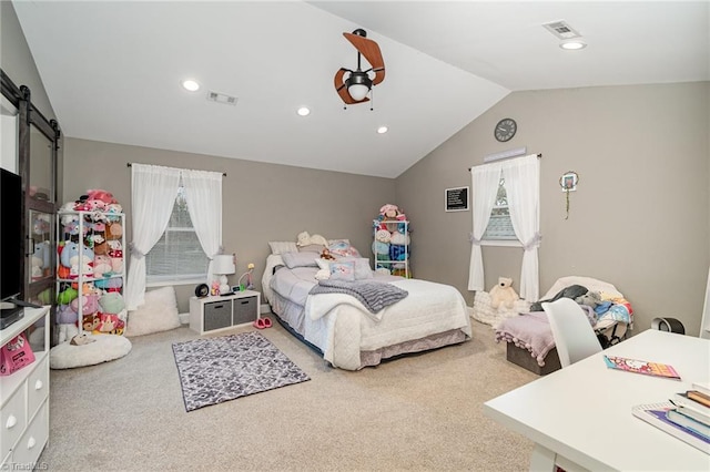 carpeted bedroom featuring visible vents, a barn door, multiple windows, and vaulted ceiling