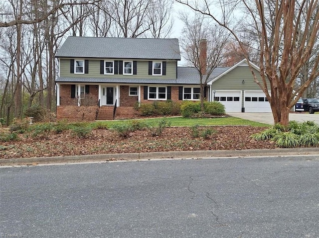 traditional home featuring a garage, concrete driveway, brick siding, and a chimney