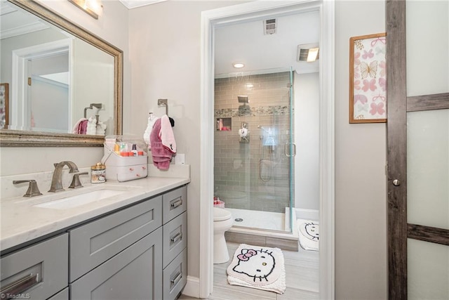 bathroom featuring vanity, a shower stall, and toilet