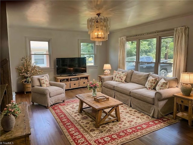 living area featuring wood finished floors and a chandelier