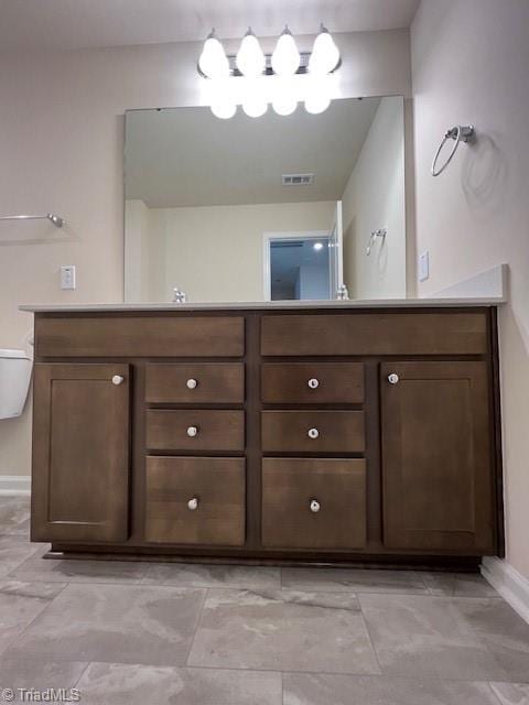 bathroom featuring toilet and vanity