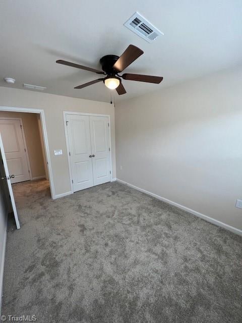 unfurnished bedroom featuring ceiling fan, a closet, and carpet