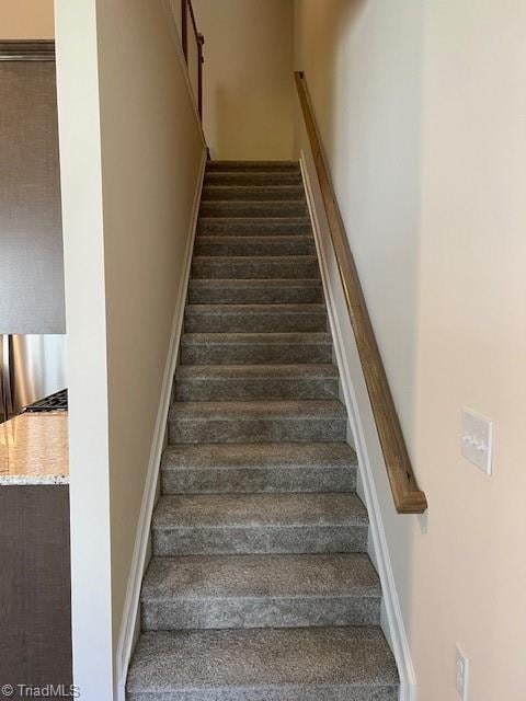 stairway featuring wood-type flooring