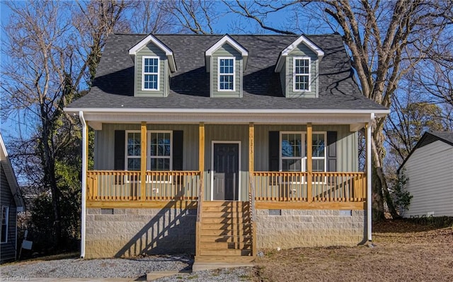 new england style home featuring covered porch