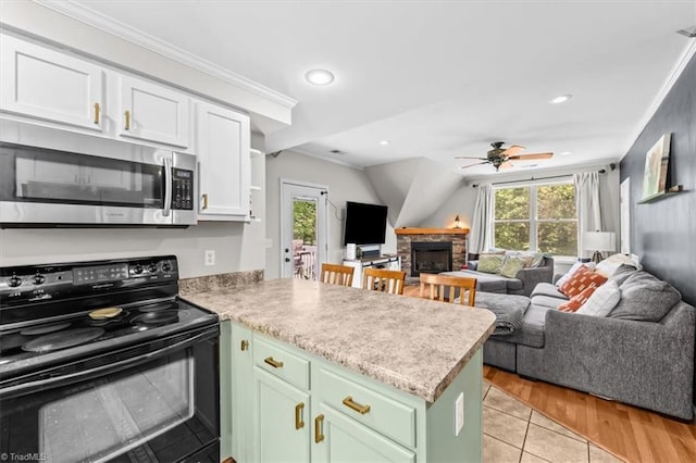 924 Delta Dr, Randleman, NC 27317 - kitchen with black / electric stove, stainless steel microwave, a peninsula, open floor plan, and crown molding
