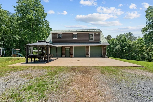 924 Delta Dr, Randleman, NC 27317 - view of front of house featuring a gazebo, driveway, a front lawn, an attached garage, and a metal roof