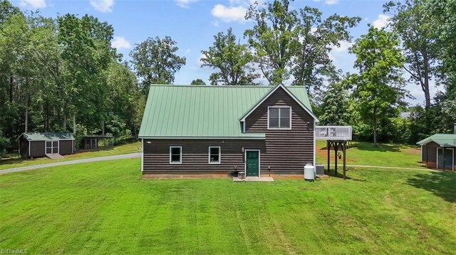 924 Delta Dr, Randleman, NC 27317 - back of property with a shed, a lawn, and a metal roof
