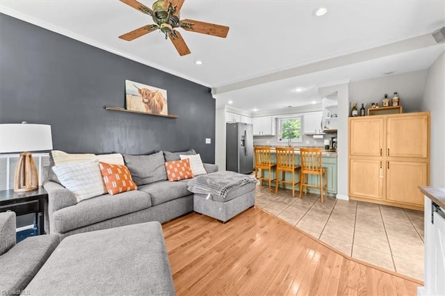 924 Delta Dr, Randleman, NC 27317 - living room with recessed lighting, ceiling fan, ornamental molding, light wood finished floors, and an accent wall