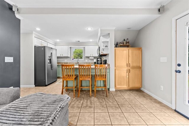 924 Delta Dr, Randleman, NC 27317 - kitchen featuring stainless steel fridge, crown molding, recessed lighting, light tile patterned floors, and light countertops
