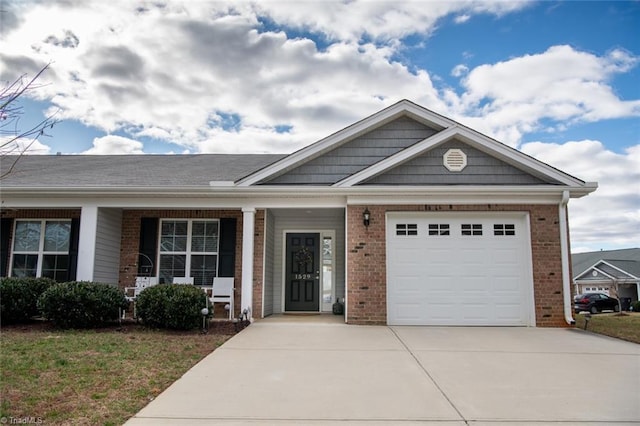 view of front of home featuring a porch, concrete driveway, an attached garage, and brick siding