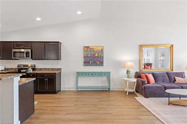 kitchen featuring dark brown cabinetry, vaulted ceiling, recessed lighting, appliances with stainless steel finishes, and light wood-style floors