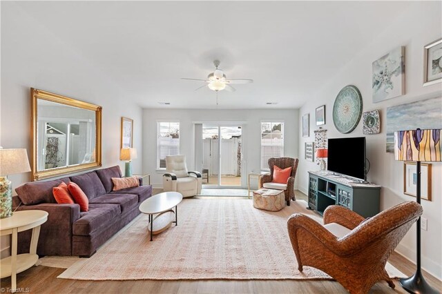 living room featuring wood finished floors and ceiling fan