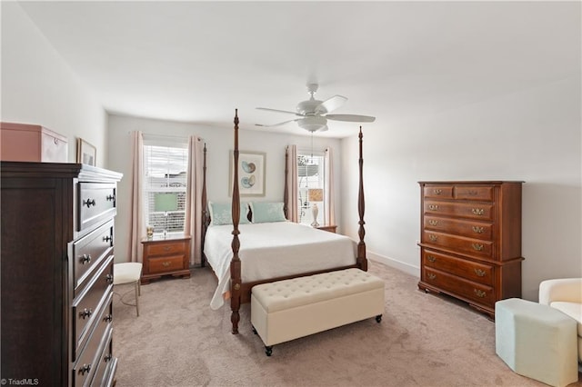 bedroom featuring a ceiling fan, baseboards, and light carpet