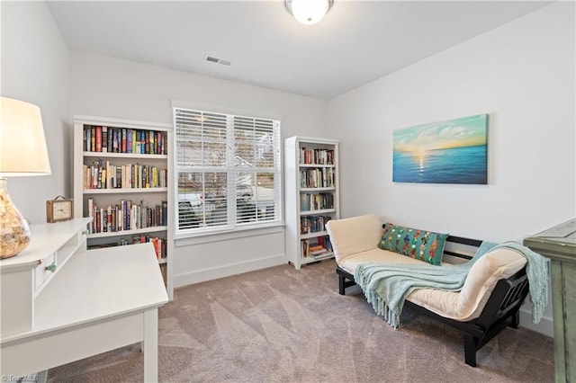 sitting room featuring baseboards, visible vents, and carpet floors